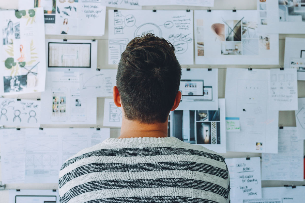 Man staring at bulletin board process