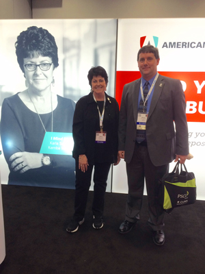 People standing next to tradeshow booth